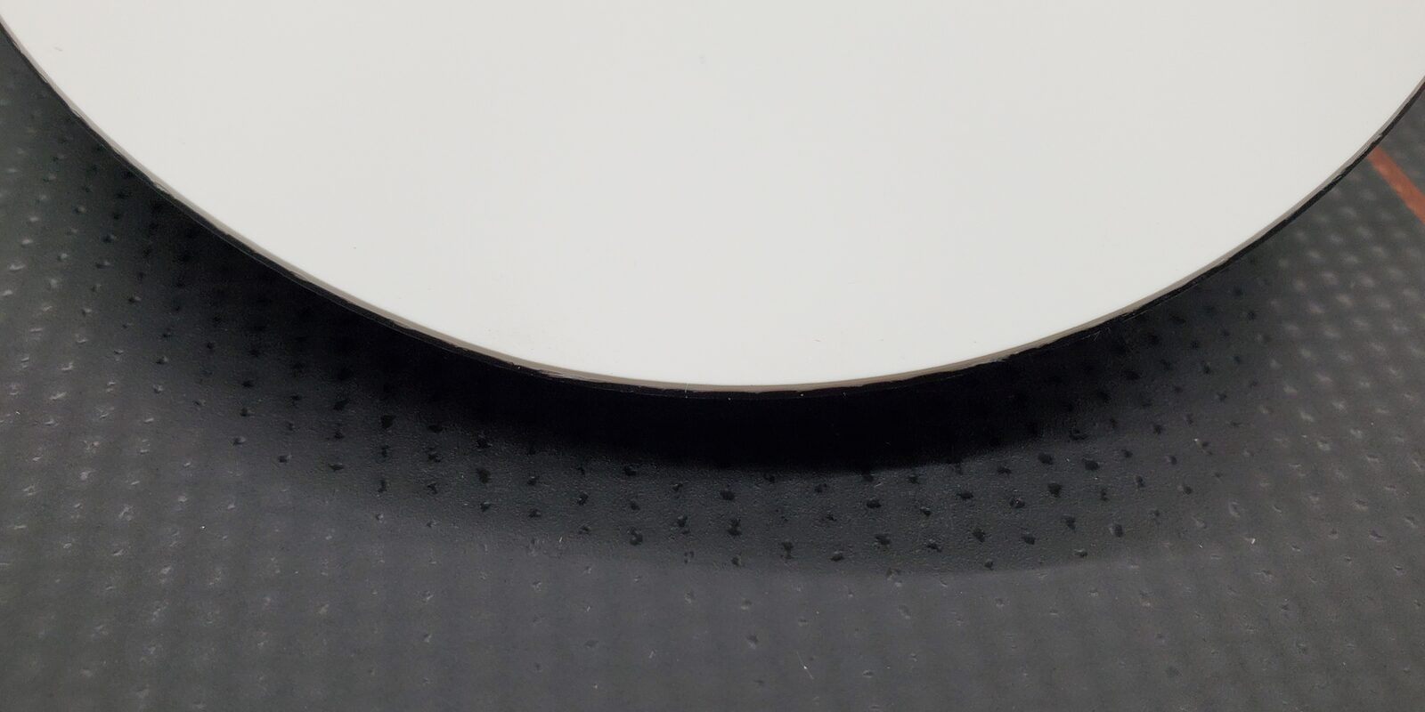 Close-up of the clean wheel-cut edge of a TPO membrane piece
