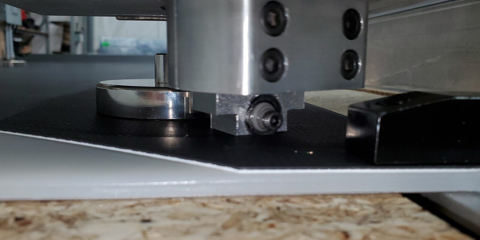Custom wheel cutter, designed and built in-house, cutting the edge of 0.06 in. TPO roofing membrane